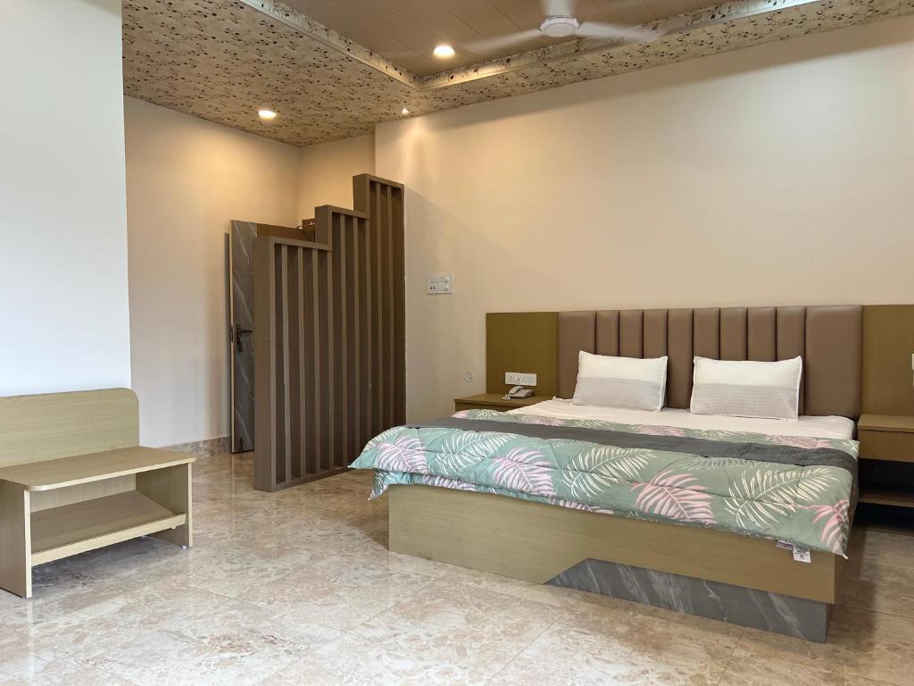 a bedroom with a bed with a wooden headboard at Kaizen Living in Guwahati