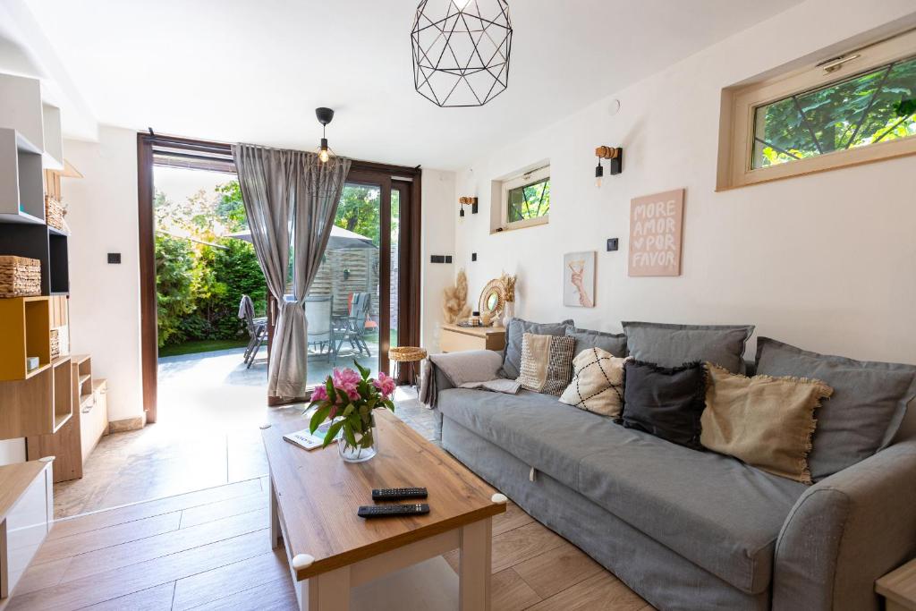 a living room with a couch and a table at Sári Apartman in Balatonalmádi