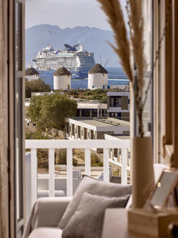 a cruise ship in the ocean viewed from a balcony at Hotel Adonis in Mikonos