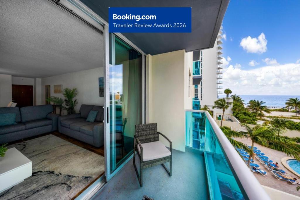 a room with a balcony with a view of the ocean at Oceanfront Luxury Condo with Stunning Views and Resort Amenities in Hollywood
