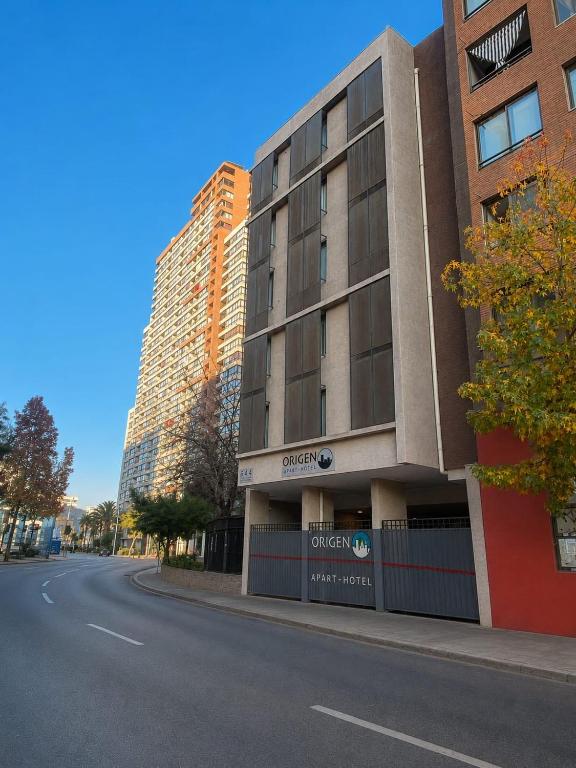 an empty street in front of a building at Origen Apart-Hotel in Santiago