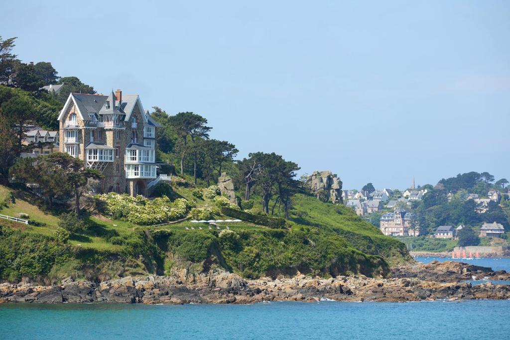 a large house on a hill in the water at Les Bassans - Fontenille Collection in Perros-Guirec