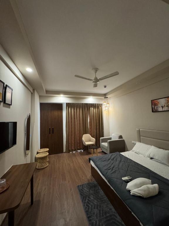 a bedroom with a bed and a living room at CasaVerve stay in Greater Noida