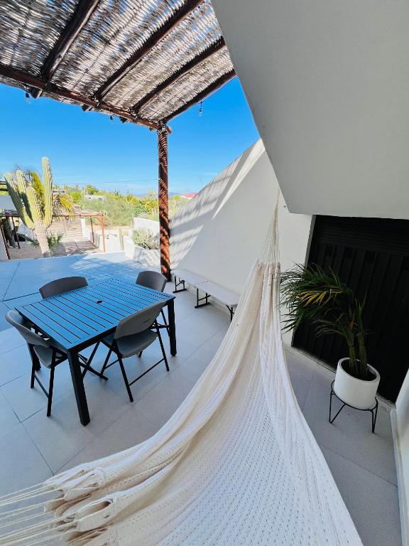 a hammock on a patio with a table and chairs at La Ventana Apartments #6 in La Ventana