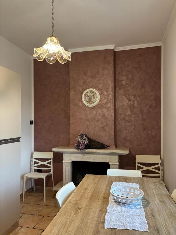 a dining room with a table and chairs and a chandelier at Casa Ciccone-L'Aquila in Tornimparte