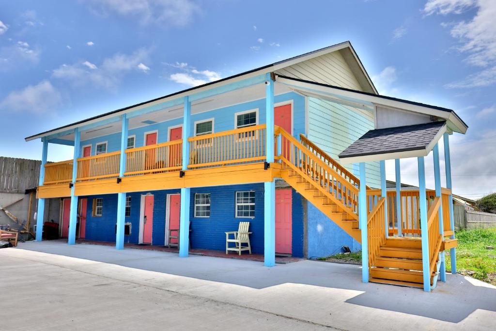a colorful house with a staircase on it at Monterrey Motel Padre Island, Corpus Christi BY OYO in Padre Island