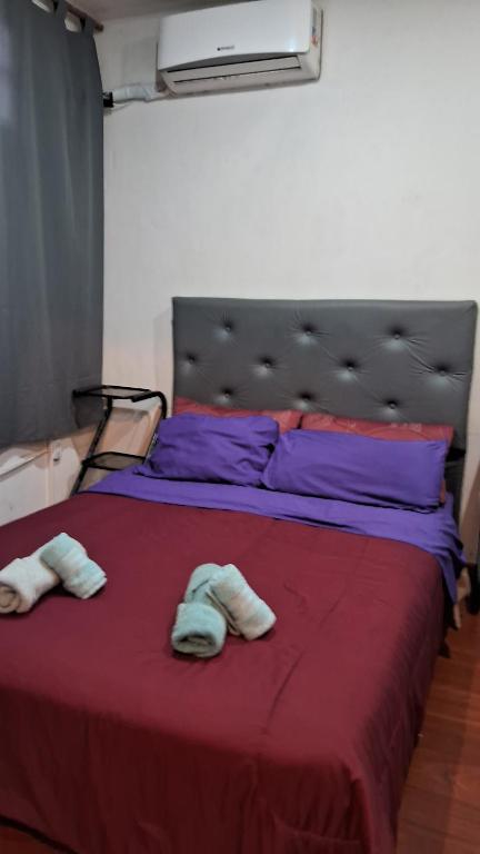 a bed with two towels on top of it at CHE LOLITA HOUSE 2 in Buenos Aires