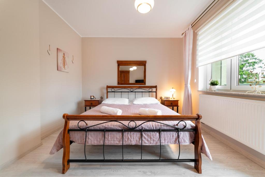 a bedroom with a bed and a window at Wenge in Jastarnia