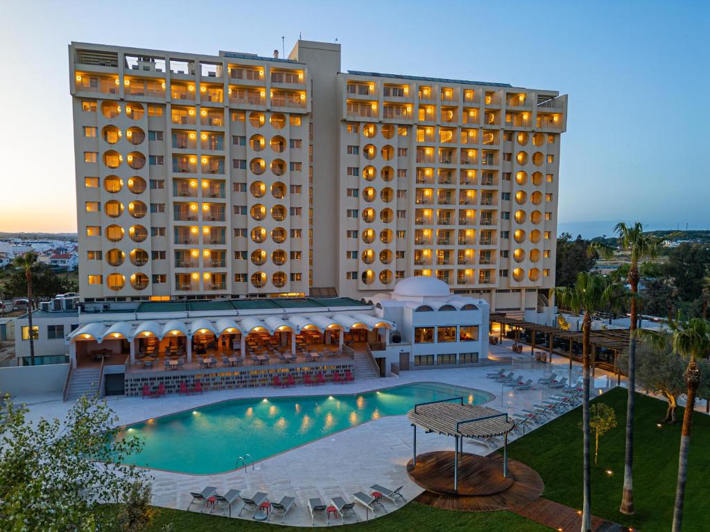 a hotel with a pool and two tall buildings at OZADI Altura Beach Resort - Eurotel Altura in Altura