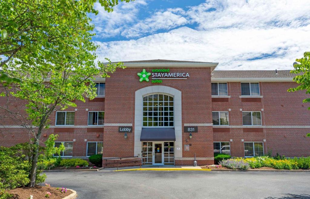 a red brick building with a pharmacy sign on it at Extended Stay America Suites - Boston - Woburn in Woburn