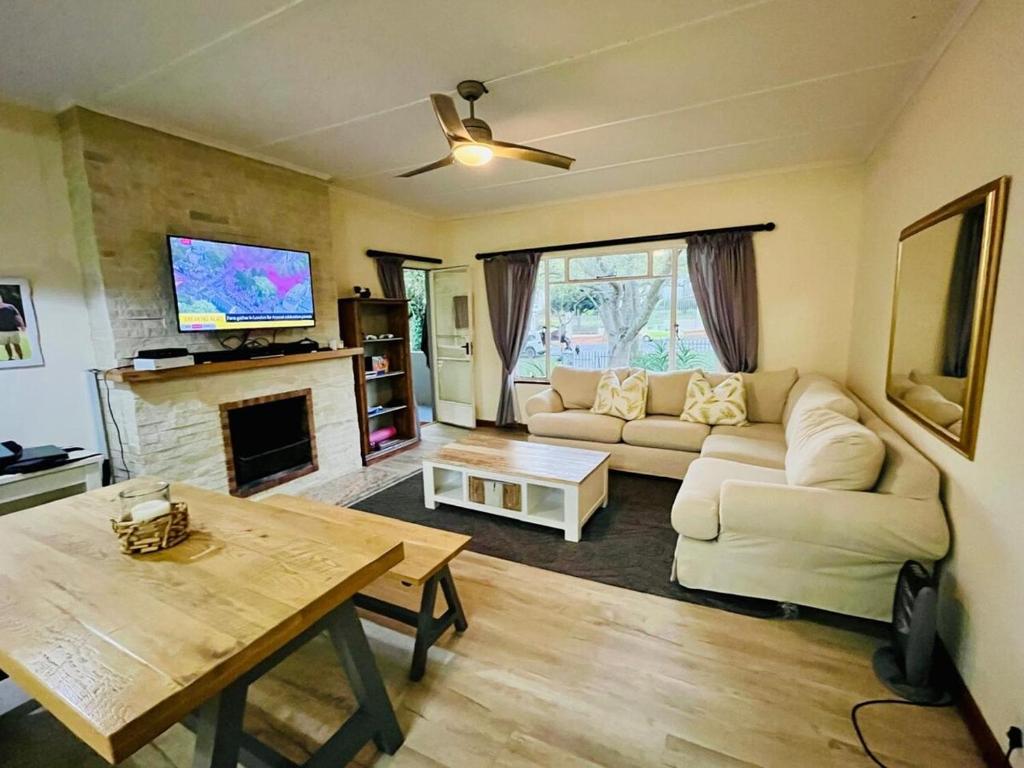a living room with a couch and a table at Pleasance Flat nr 8A Worcester Street in Grahamstown