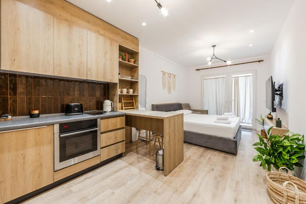 a kitchen and living room with a bed in the background at NooN Apartment | Sofo Duni by PikHost in Dhërmi