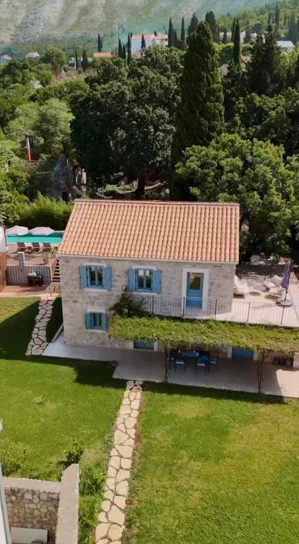 a house with a red roof and a yard at Villa Fig & Oak in Mlini