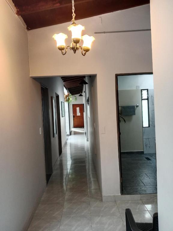 a hallway in a house with a chandelier at Envigado tradicion y modernidad in Envigado