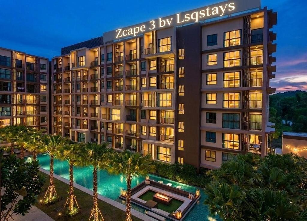 an image of a building with a pool and palm trees at Zcape garden by lsqstays in Ban Rangeng