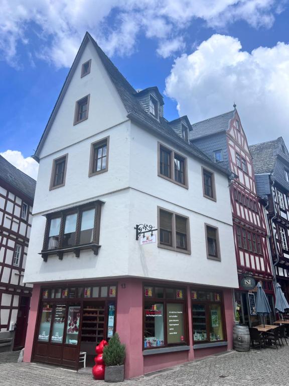 a large white building with windows on a street at Altstadtappartment Plötze 13 Limburg in Limburg an der Lahn