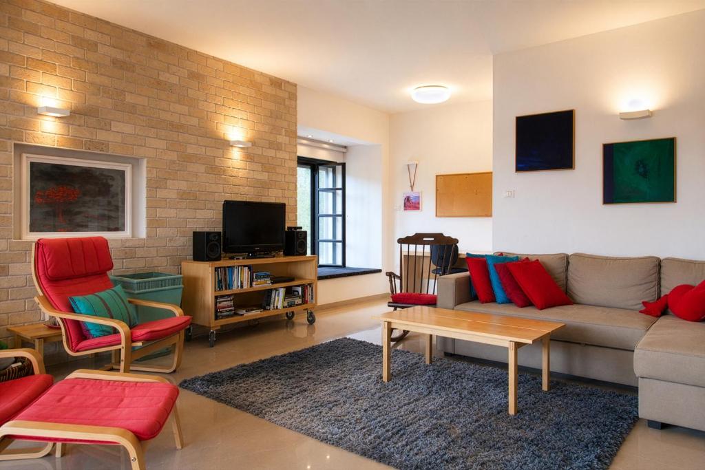 a living room with a couch and chairs and a table at Carmel Home Mount Seaview in Haifa
