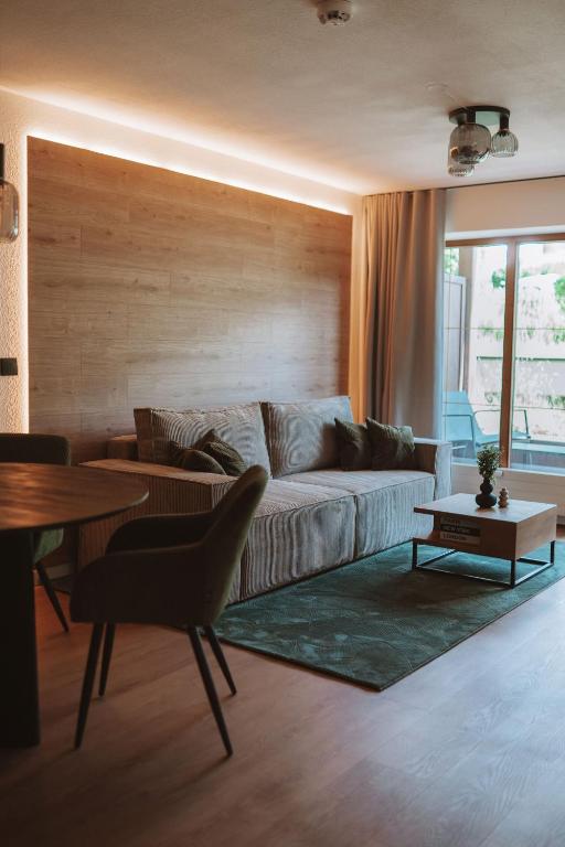 a living room with a couch and a table at ALPEN STUDIO - moderne Ferienwohnung mit Bergblick & Südterrasse in Bad Hindelang in Bad Hindelang