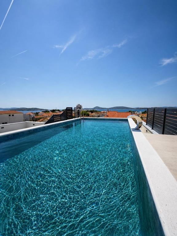 a swimming pool on the roof of a building at Apartments Maritea in Vodice