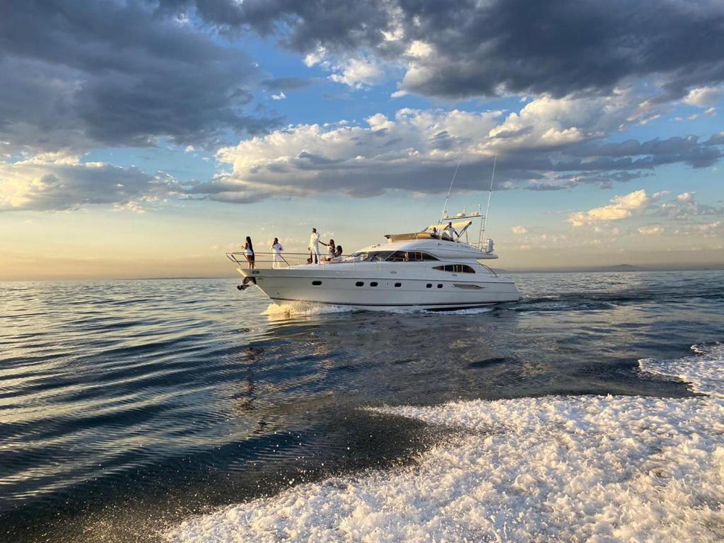 a group of people on a boat in the water at Only One Yacht Cape Town in Cape Town