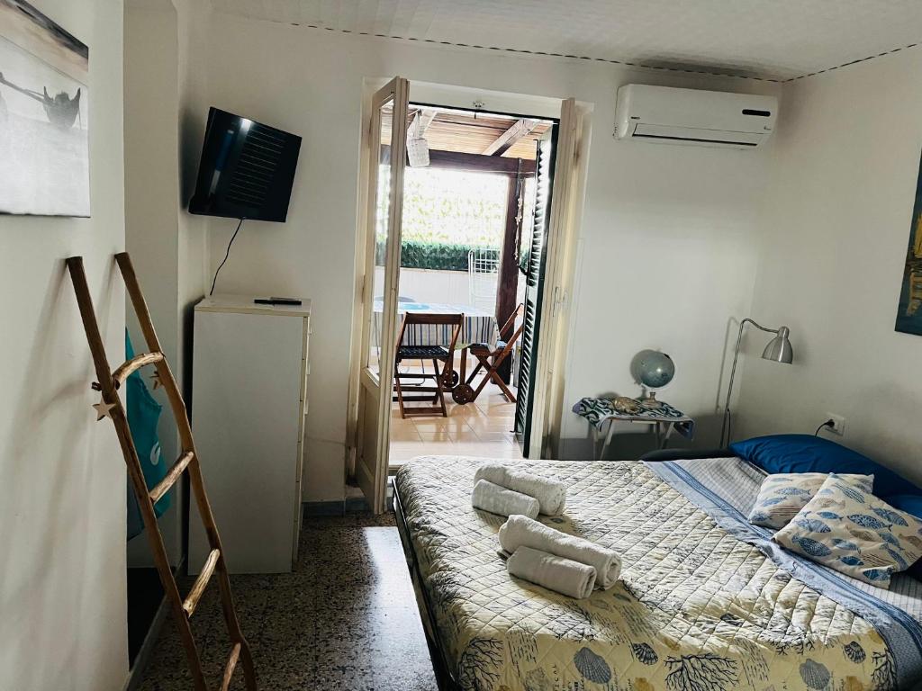 a bedroom with a bed and a door to a patio at Casa Stella Marina in Anzio