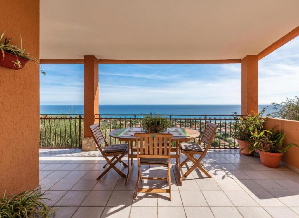 a patio with a table and chairs and the ocean at Villa Fior di mare in Monte Nai
