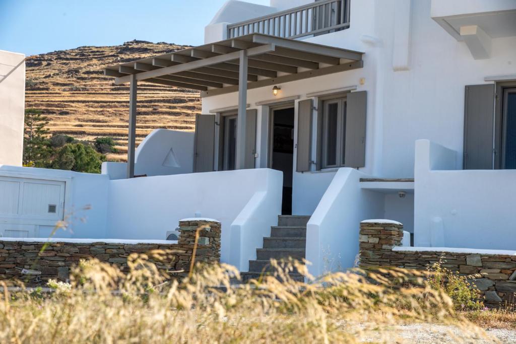 a white house with stairs and a porch at Easy Living Tinos in Vrachonisída Chántra