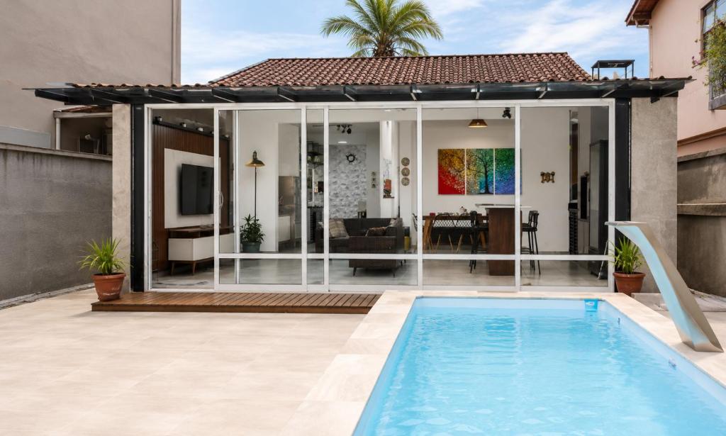 a villa with a swimming pool and a house at Casa no Litoral , com Piscina Privativa em Ubatuba in Ubatuba