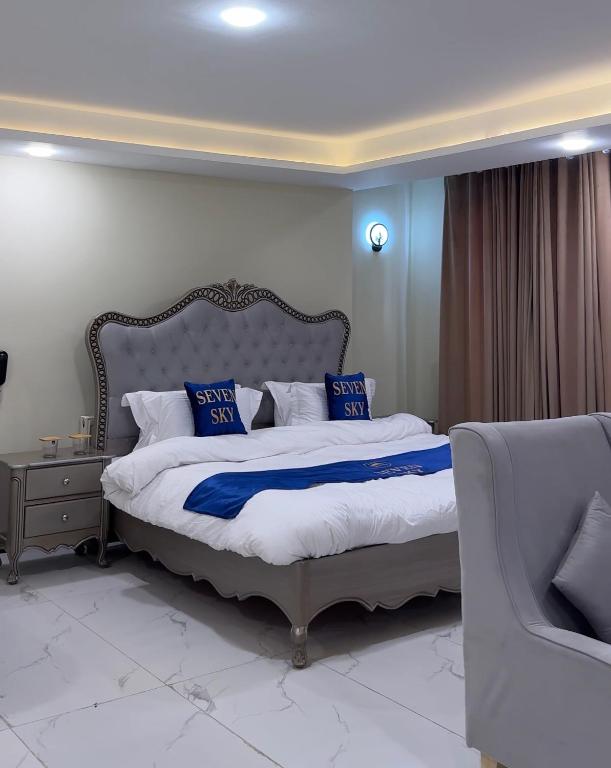 a bedroom with a bed with blue and white pillows at Seven sky hotel in Murree
