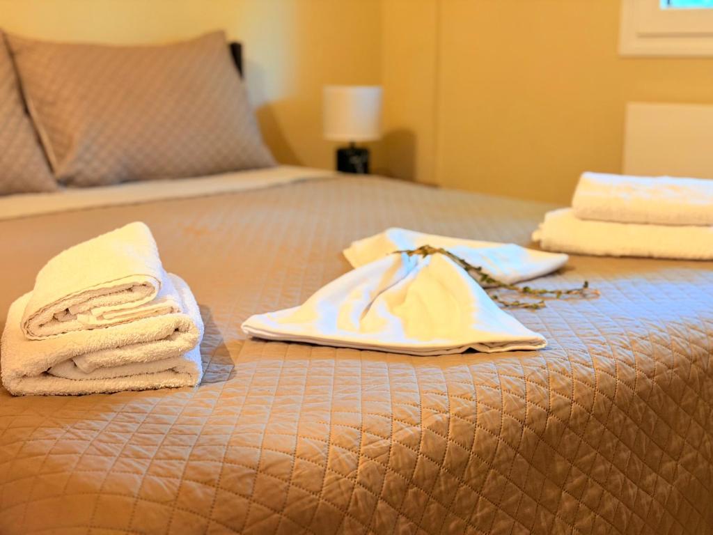 a bed with towels sitting on top of it at Shell-paralia ofriniou in Ofrínion