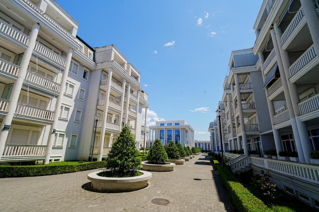 a row of christmas trees inront of buildings at Neni apartament in Velipojë
