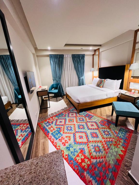 a hotel room with a bed and a rug at Lahore Continental Hotel in Lahore