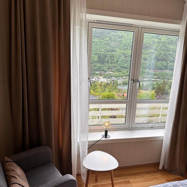 a living room with a window with a chair and a chair at Otta Studio apartment in Sel