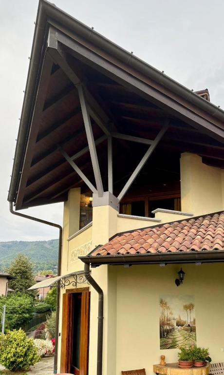 a house with awning on the side of it at Vista Lago B&B in Gavirate