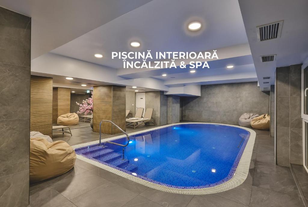 a large blue swimming pool in a building at Hotel Dorna in Vatra Dornei