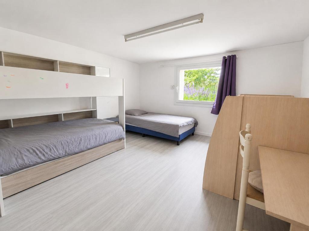 a bedroom with two bunk beds and a window at maison d'hôte et espace de repos in Prades
