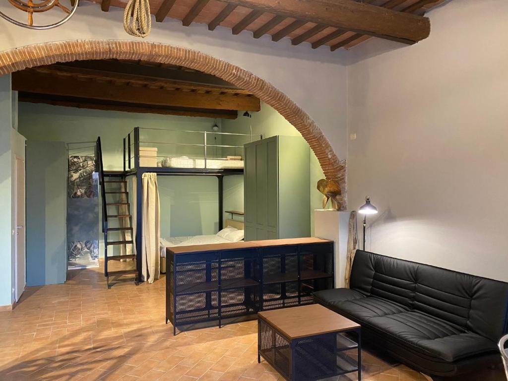 a living room with a couch and a bunk bed at Loft Open Space, Capoliveri Centralissimo in Capoliveri