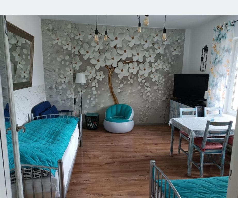 a bedroom with a bed and a table and a dining room at Centrum 3 łóżka Roosevelta 47 in Piła