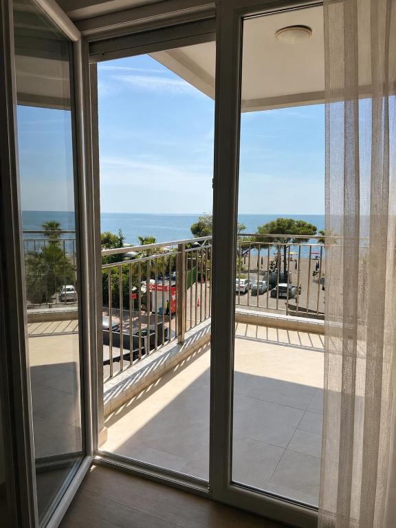 a room with a window looking out at the ocean at Apartments Kristi in Shëngjin