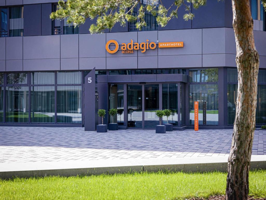 an office building with a sign on the front of it at Adagio Access Stuttgart Airport Messe in Leinfelden-Echterdingen