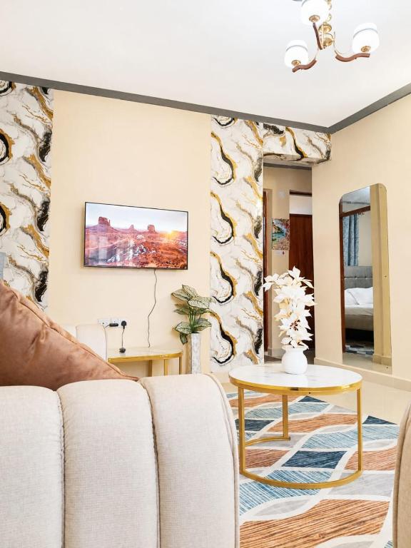 a living room with a couch and a table at Joyland B&B in Mbita