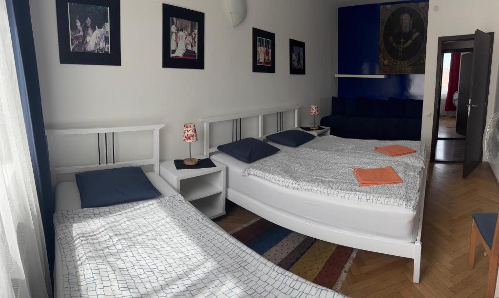 a bedroom with two beds and a mirror at Apartment Maximilian in Bratislava