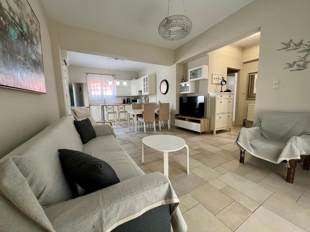 a living room with a couch and a table at Salve Suite in Lefkada