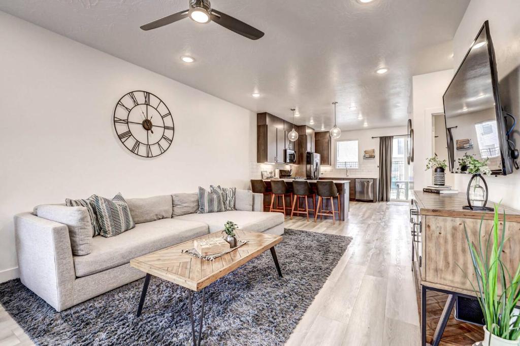 a living room with a couch and a table at Poolside Retreat - King Beds - Dog Friendly in St. George