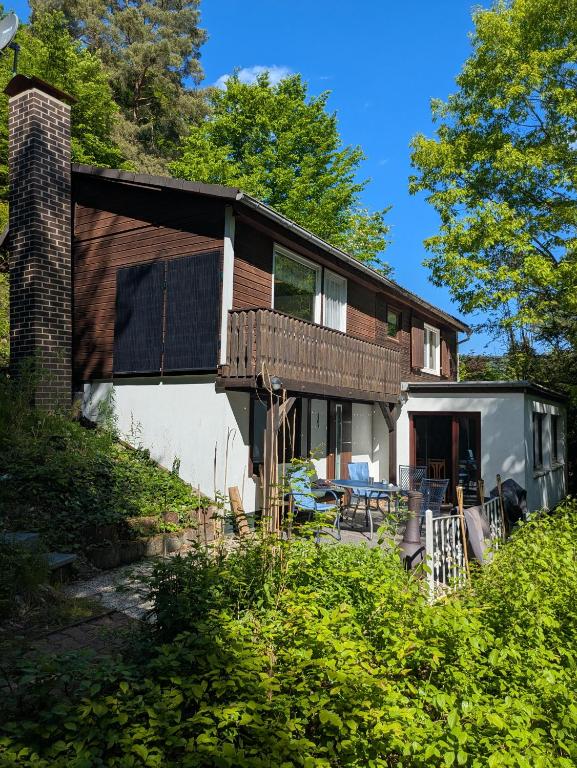 a house with a wrap around porch with a deck at Kleiner Fuchsbau in Kleinern