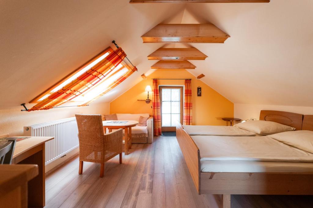 a bedroom with a bed and a table and a couch at Pension MÜLLER - ehemals Pension Wenger in Kirchheim im Innkreis