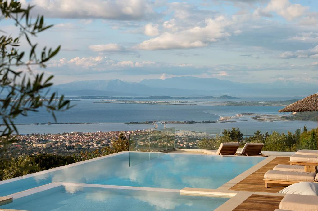 a swimming pool with a view of the water at Anemones Villas by Omikron Selections in Spanokhórion