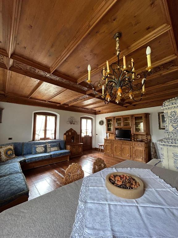 a living room with a table and a chandelier at Panorama Lodge in Cortina dʼAmpezzo