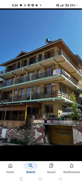 a picture of a large apartment building at Katha Inn in Manāli