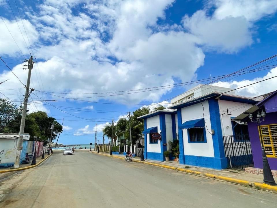 an empty street in a town with blue and white buildings at La Posada Azul Boutique Hotel Coco SA in San Juan del Sur